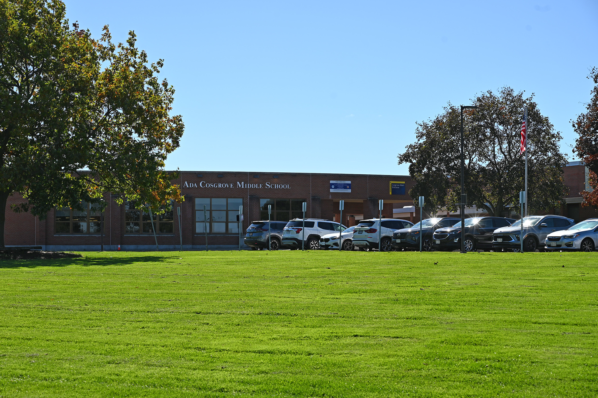 Cosgrove sits behind a wide green lawn on a bright, sunny day.